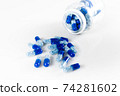 Blue medical capsules on the white background 74281602