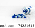 Blue medical capsules on the white background 74281613