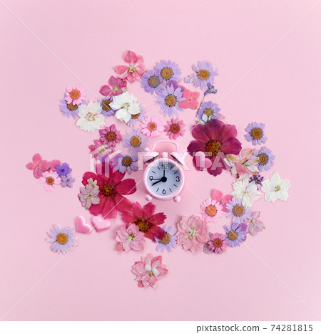 Pink alarm clock with flowers. Time for greetings and love. Flat lay. Pink alarm clock with flowers. Time for greetings and love. Flat lay. 74281815