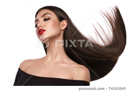 Beautiful brown-haired girl with a perfectly smooth hair, and classic make-up. Beauty face and hair. 74283045