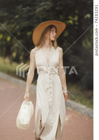 Woman with Flowers in Nature in the Summer. Woman with Flowers in Nature in the Summer. 74283291
