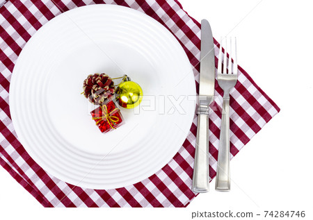 Christmas and New Years concept. White plate, red tablecloth. Studio Photo Christmas and New Years concept. White plate, red tablecloth. Studio Photo 74284746