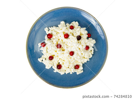 Milk products. Farm cottage cheese with red berries on plate. Studio Photo 74284810