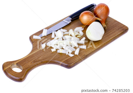 Slices of chopped onion on kitchen cutting board. Studio Photo Slices of chopped onion on kitchen cutting board. Studio Photo 74285203