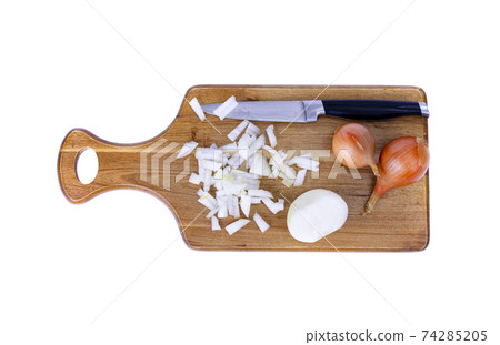 Slices of chopped onion on kitchen cutting board. Studio Photo Slices of chopped onion on kitchen cutting board. Studio Photo 74285205