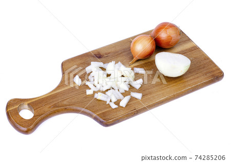 Slices of chopped onion on kitchen cutting board. Studio Photo Slices of chopped onion on kitchen cutting board. Studio Photo 74285206