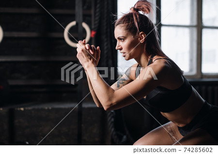 Young girl doing sports in the gym. Atmospheric gym Young girl doing sports in the gym. Atmospheric gym 74285602