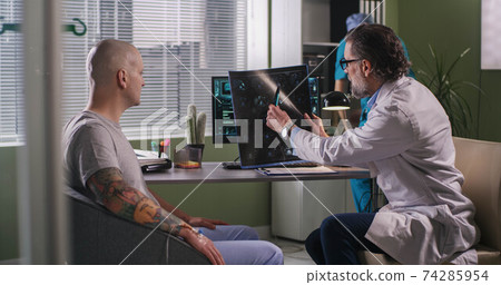 Doctor delivering bad news to patient during chemotherapy Doctor delivering bad news to patient during chemotherapy 74285954