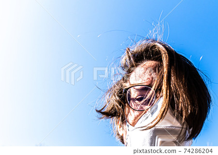 Man with disheveled hair with a face mask Man with disheveled hair with a face mask 74286204