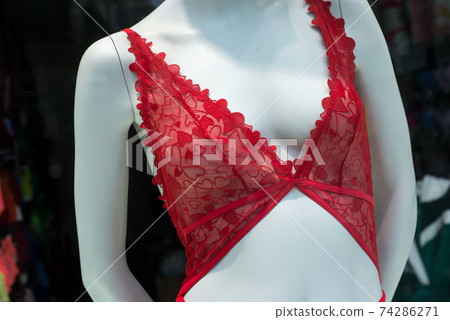 closeup of red bra with little hearts on mannequin in a fashion store showroom closeup of red bra with little hearts on mannequin in a fashion store showroom 74286271