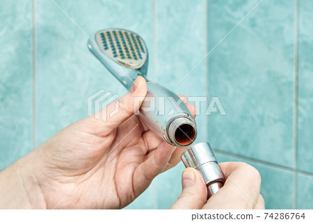 Rust inside old shower head being disassembled. Rust inside old shower head being disassembled. 74286764