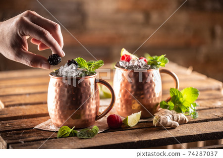 Moscow Berry Mule highball vodka cocktail is a long drink with fresh lime juice, ginger beer and berries Moscow Berry Mule highball vodka cocktail is a long drink with fresh lime juice, ginger beer and berries 74287037