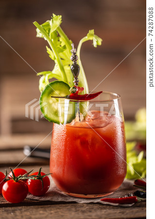 Classic bloody mary or virgin mary vodka cocktail in a cup with as a hangover drink in a rustic envrionment Classic bloody mary or virgin mary vodka cocktail in a cup with as a hangover drink in a rustic envrionment 74287088