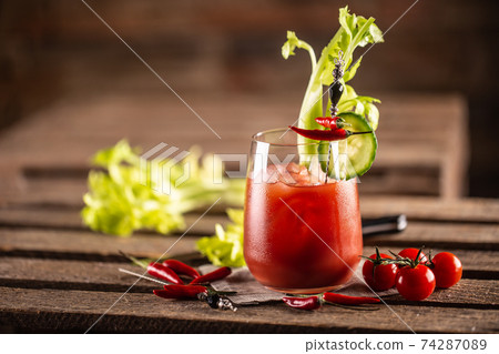Classic bloody mary or virgin mary vodka cocktail in a cup with as a hangover drink in a rustic envrionment Classic bloody mary or virgin mary vodka cocktail in a cup with as a hangover drink in a rustic envrionment 74287089