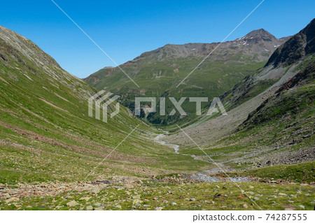 View into a typical trough valley in the Grisons mountains, Switzerland View into a typical trough valley in the Grisons mountains, Switzerland 74287555