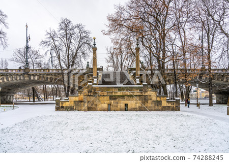 Stone brige staircase covered by snow 74288245