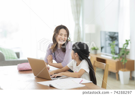 Girl and mother studying on a computer Girl and mother studying on a computer 74288297