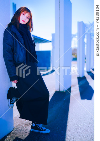 Girls in blue sky, white walls and black clothes Girls in blue sky, white walls and black clothes 74289104