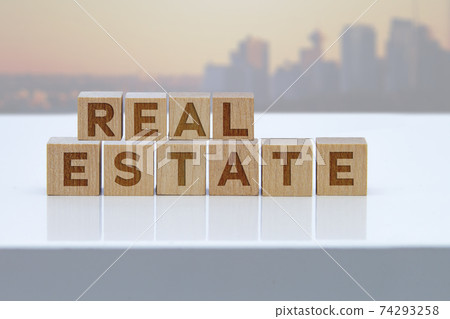 'Real Estate' message sign on wooden blocks sitting on a white table. 'Real Estate' message sign on wooden blocks sitting on a white table. 74293258