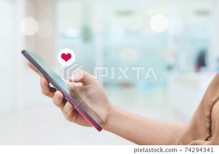 Hand using smartphone look message from lovers. She sending a message encouraging to boyfriend 74294341