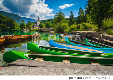 Harbor with rowing boats and colorful canoes, lake Bohinj, Slovenia Harbor with rowing boats and colorful canoes, lake Bohinj, Slovenia 74296185