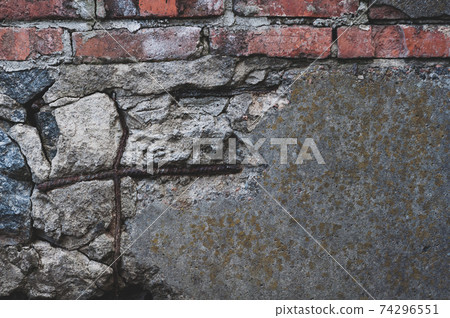 Old shade with red dirty bricks. Cracked foundation with chipped piece cement and rusty reinforcement sticking out. Old shade with red dirty bricks. Cracked foundation with chipped piece cement and rusty reinforcement sticking out. 74296551