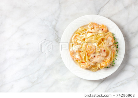 Pasta with shrimps, cream sauce, and thyme, overhead shot Pasta with shrimps, cream sauce, and thyme, overhead shot 74296908
