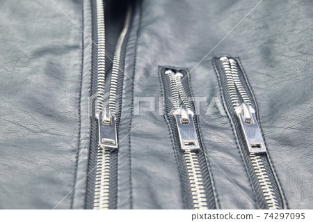 Detail of the metal zippers of the classic black leather jacket. Fashion concept 74297095