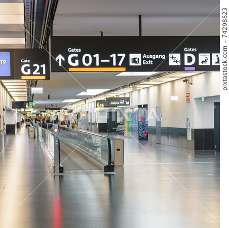 Peoples walking in Vienna airport terminal Peoples walking in Vienna airport terminal 74298823