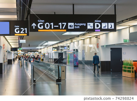 Peoples walking in Vienna airport terminal Peoples walking in Vienna airport terminal 74298824
