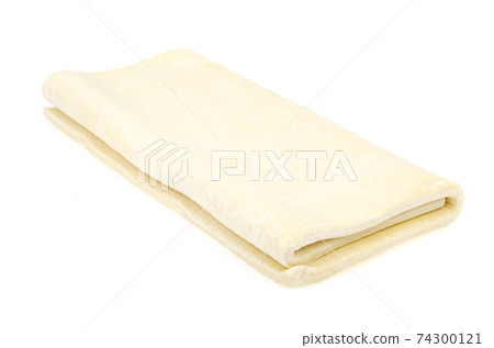 Folded plate raw dough on white background. 74300121