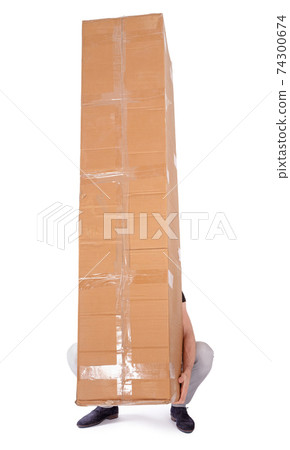 Man carrying a oversized cardboard box Man carrying a oversized cardboard box 74300674