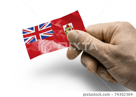 Hand holding a card with a national flag the Bermuda Hand holding a card with a national flag the Bermuda 74302364