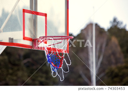 basketball hoop or ring on blurry outdoor background 74303453