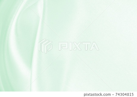 Smooth elegant green silk or satin luxury cloth texture as abstract background. Luxurious background design 74304815