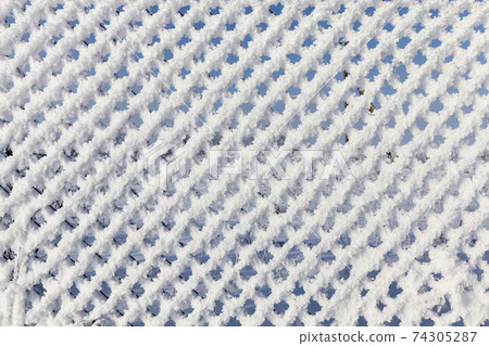metal mesh netting covered with snow metal mesh netting covered with snow 74305287