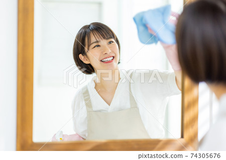 Image of a young woman cleaning at home Image of a young woman cleaning at home 74305676