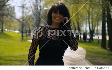 Attractive woman walking in the park 74306344