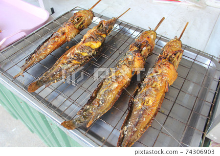 close up potrage photo of grilled catfish Thai street food, foods travel and cuisine concept 74306903