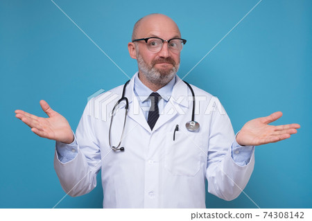 Experienced male doctor standing with open arms asking so how. Experienced male doctor standing with open arms asking so how. 74308142