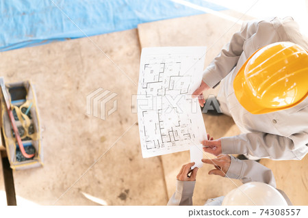 People working at a housing construction site, skeleton remodeling meeting, presenting business cards People working at a housing construction site, skeleton remodeling meeting, presenting business cards 74308557