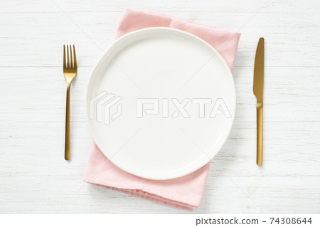 White empty plate and golden cutlery on wooden table. 74308644