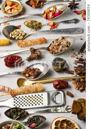 Healing herbs in teaspoons 74309854