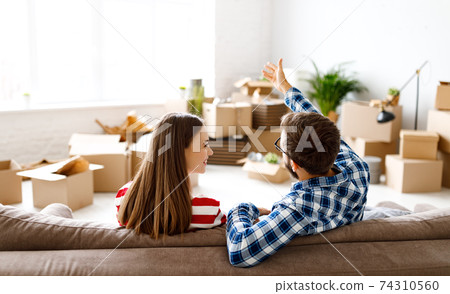 Happy couple discussing interior of new home Happy couple discussing interior of new home 74310560