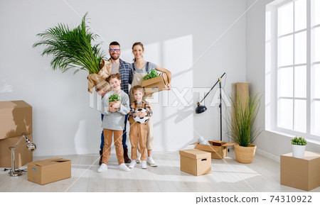 Content family with boxes moving in new apartment 74310922