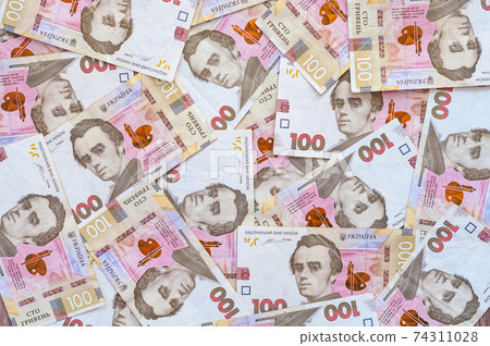 Paper money, Ukrainian hryvnia in denomination 100 hryvnia, new money, background with scattered banknotes 74311028