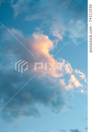 Beautiful lush cloud, colorful bright sunrise, warm shades sky with warm rays sun. 74311030