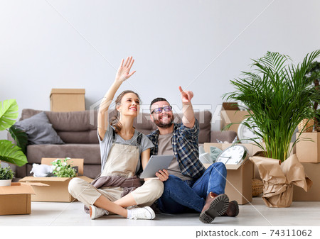 Happy couple during moving in new apartment 74311062