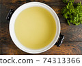 Pure fish broth in casserole, top view 74313366