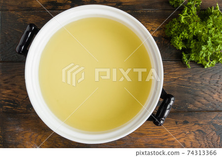 Pure fish broth in casserole, top view 74313366